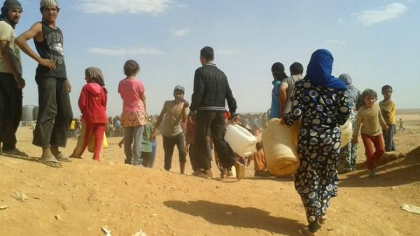 Syrian refugees look for water at the Rukban camp on the Jordanian border. (AFP/File)
