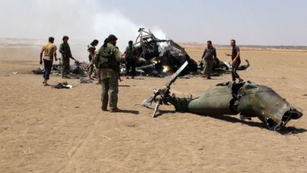 Syrian rebels gather around the wreckage of a Russian Mi-8 military transport helicopter. (AFP/File)