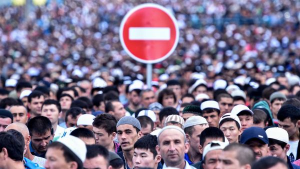 A traffic sign is seen behind Russian Muslims praying outside the central mosque in Moscow on Tuesday, during celebrations of Eid al-Fitr marking the end of the fasting month of Ramadan. (AFP/File)