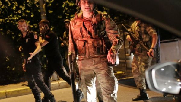 Turkish security officers detain Turkish police officers (in black) on July 15, 2016. (AFP/File)