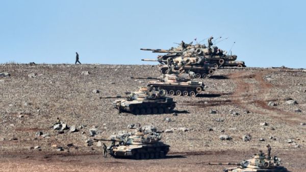 Turkish tanks line up on a hill near the border with Syria as Daesh jihadists besieged Kobane in 2014. (AFP/Aris Messinis)