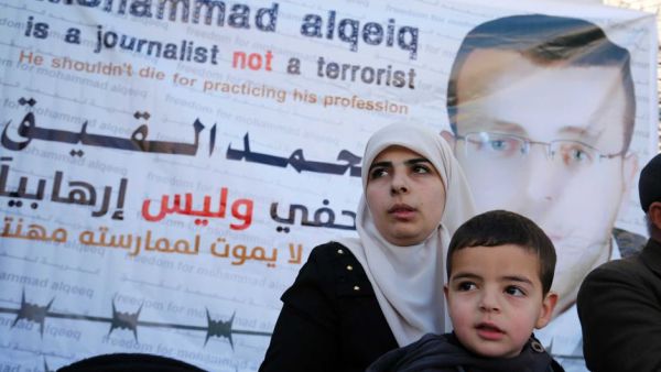Fayha Shalash, the wife of Mohammed al-Qiq, with her son Islam. (AFP/Abbas Momani)