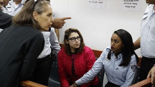 Nour Tamimi (C) who is being detained after a viral video showing her with two members of her family allegedly assaulting two Israeli soldiers is seen in a military court at the Ofer prison in the West Bank on December 28, 2017. (Ahmad Gharabli/AFP)