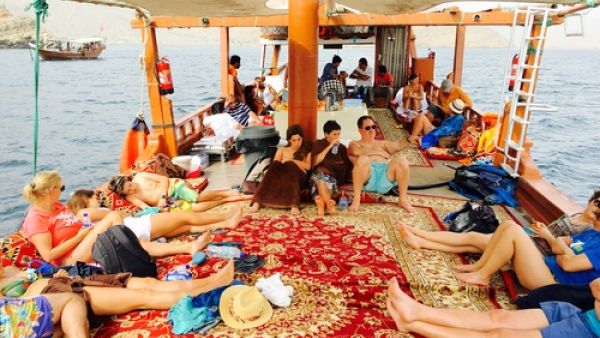 Tourists on a dhow boat in the Strait of Hormuz, Musandam, Oman. (Shutterstock/Imran's Photography)