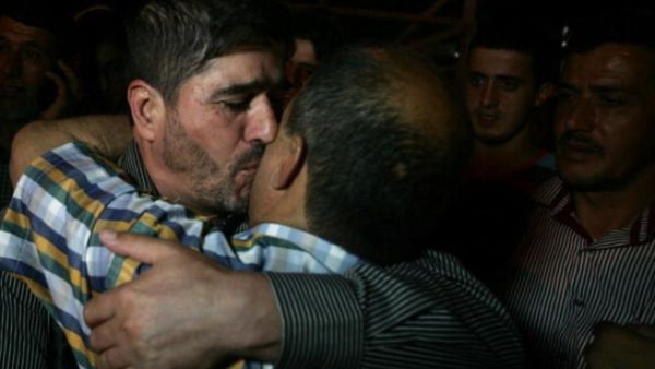 One of the Palestinian leaders of the Islamic Jihad movement in the West Bank, Jaafar Ezzeddine embraces a relative after being release from an Israeli prison in the West Bank city of Jalama, near Jenin, on May 8, 2013. (SAIF DAHLAH/AFP/Getty Images)