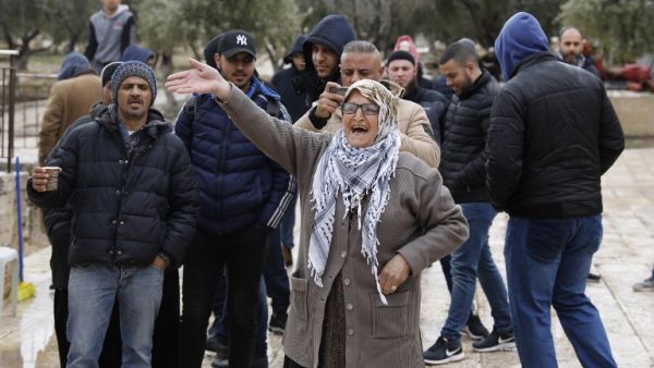 Palestinian Muslims protest as Jews visit the Al-Aqsa mosque compound in the Old City of Jerusalem escorted by security forces on March 14, 2019. AHMAD GHARABLI / AFP