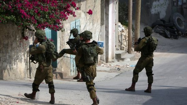 Israeli soldiers conduct searches in the northern West Bank village of Madama on August 24, 2016 after a Palestinian reportedly exited a car and stabbed an Israeli soldier on a road close to the village and to the Israeli settlement of Ariel. (AFP/Jaafar Ashtiyeh)