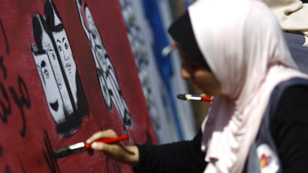 A Palestinian art student paints as she takes part in a festival marking the World Mental Health Day on October 11, 2016 in Gaza City. (AFP/Mohammed Abed)