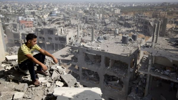 A Palestinian man overlooks destruction in Gaza City's al-Tufah neighborhood, during the second day in a ceasefire on Aug. 6, 2014. (AFP/Mahmud Hams)