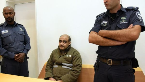Palestinian Mohammed Halabi (C), the Gaza director of World Vision, a major US-based Christian NGO, looks on during his indictment at a district court in the southern Israeli city of Beersheva on August 4, 2016. (AFP/Dudu Grunshpan)