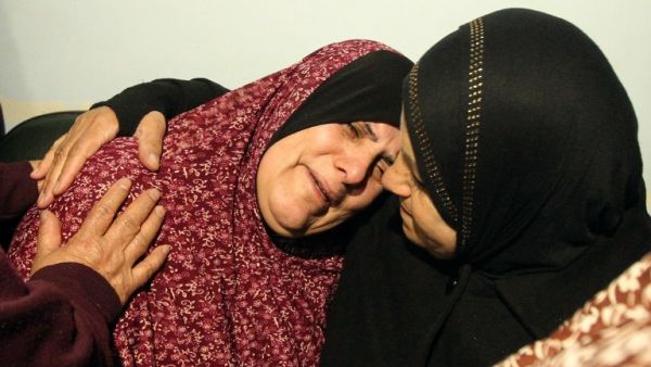 The mother of Omar Maddi, 16, is comforted by a relative as she mourns the death of her son in the al-Mizan hospital in Hebron on February 10, 2016 after he was killed by Israeli security forces in Al-Arroub refugee camp. (AFP/Hazem Bader)