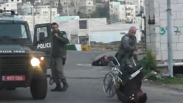 Palestinian man is knocked out of his wheelchair (Facebook / Raed Abu Rumaila)