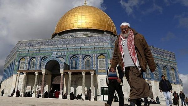 A Palestinian man walks past Al-Aqsa Mosque compound before the Friday prayer in Jerusalem's Old City on January 13, 2017. (AFP/Ahmad Gharabli)