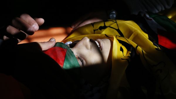The body of Mahmud Hattab, 16, at his funeral in al-Jalazun refugee camp, March 24 2017. (AFP/Abbas Momani)