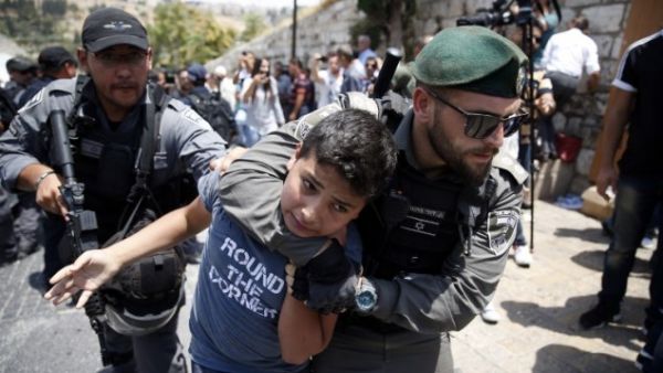 Israeli border guards detain a protester during a demonstration outside the Lions Gate in Jerusalem's Old City on July 17, 2017. (AFP/ Ahmad Gharabli)