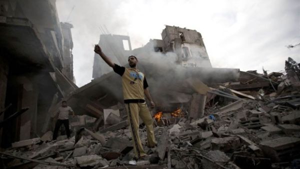 A Palestinian man stands amid debris following an Israeli air strike in Gaza City on July 11, 2014. (AFP/ Mohammed Abed)
