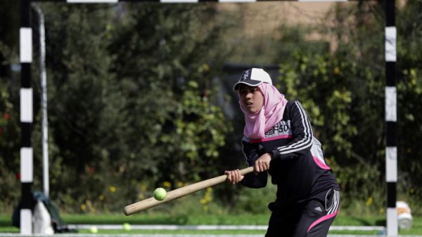 The women who make up Gaza's first baseball team don caps over their hijabs and often play using improvised equipment, like tennis balls. (AP Photo)