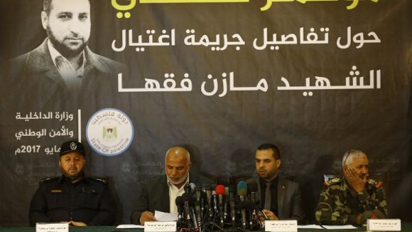 Tawfiq Abu Naim (2nd L), head of Hamas-run security forces in Gaza, speaks during a press conference on the killing of senior Hamas official Mazen Faqha, in Gaza City, on May 16, 2017. (Mohammed Abed/AFP)