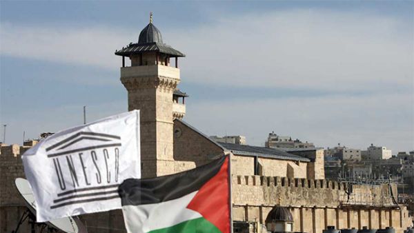 The Palestinian Rehabilitation Committee raised the UNESCO flag next to the national Palestinian flag in front of Hebron's Ibrahimi Mosque or the Tomb of the Patriarchs. (Hazem Bader/ AFP) The Palestinian Rehabilitation Committee raised the UNESCO flag next to the national Palestinian flag in front of Hebron's Ibrahimi Mosque or the Tomb of the Patriarchs. (Hazem Bader/ AFP)