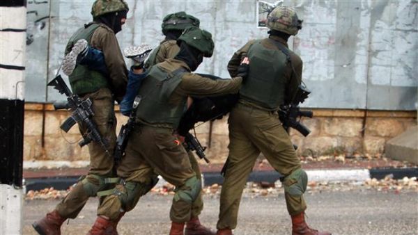 Israeli soldiers carry a Palestinian after he was detained during clashes in the West Bank city of Bethlehem. (AFP/ File)