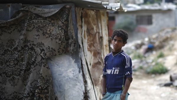A Palestinian boy stands outside his home in Gaza City, on April 27, 2017. (AFP/Mohammed Abed)