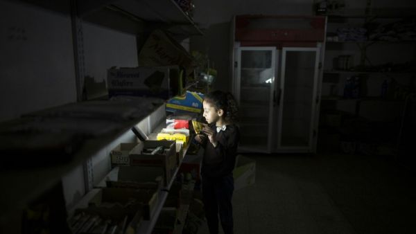 A Palestinian girl shops for sweets at the Al-Shati refugee camp in Gaza City during a power outage on June 11, 2017. (Mahmud Hams/AFP)