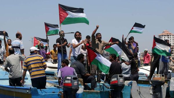 Palestinians rally, Tuesday, in the port of Gaza in support of a flotilla that aimed to break the blockade ( AFP/ File photo)