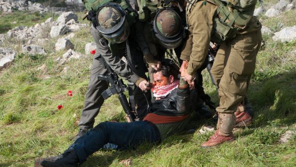 Israeli soldiers pepper spray a Palestinian as they crackdown on protest over land belonging to the West Bank. (Shutterstock/ File Photo)