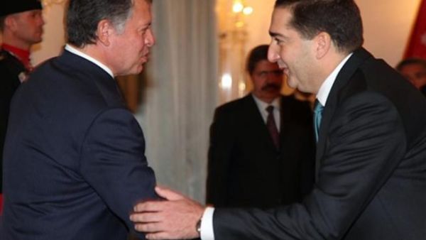Jordan's Prime Minister Samir Rifai (R) shaking hands with Jordan's King Abdullah after taking the oath of office in Amman on November 24, 2010. King Abdullah once described Jordan as between "Iraq and a hard place."