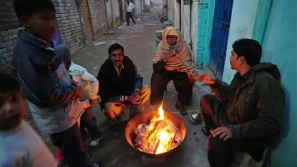 Islamabad : Pakistani Christian warm themselves around a fire in the slum area of Islamabad