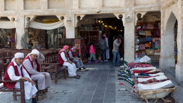 Porters with their barrows await work outside part of the imposing Souq Waqif tourist attraction in Doha. (Shutterstock/Peter Cowan)