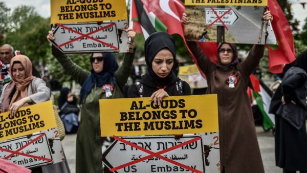 Women protestors hold placards reading "Al Quds belongs to the Muslims" /AFP