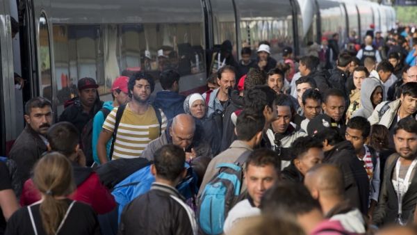 Refugees arrive at a train station in Berlin (Axel Schmidt/AFP)