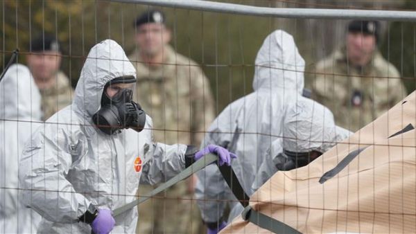 Military personnel wearing protective coveralls work to remove a vehicle connected to the nerve agent attack in Salisbury from a residential street in Gillingham, southeast England, on March 14, 2018. (AFP/ File Photo)