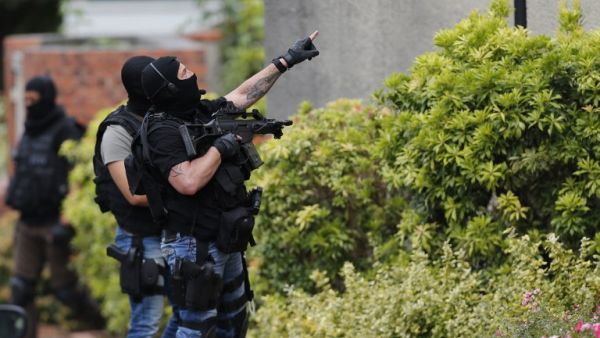 French policemen search house-by-house in Saint-Etienne-du-Rouvray after attackers killed a priest at a church in the village. (AFP/Charly Triballeau)