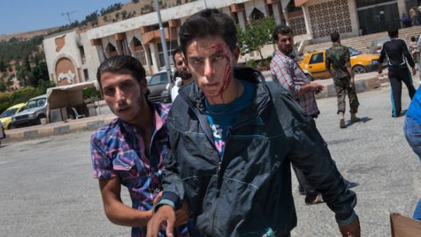 A wounded Syrian man arrives to receive treatment at Bab al-Hawa hospital near Syria's rebel-controlled border with Turkey (Source: AFP/DANIEL LEAL-OLIVAS)