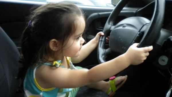 Little girl takes the wheel after father leaves car running. [blogspot]