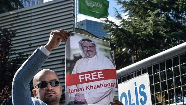 A protester holds a picture of missing journalist Jamal Khashoggi during a demonstration in front of the Saudi Arabian consulate. (AFP/File)