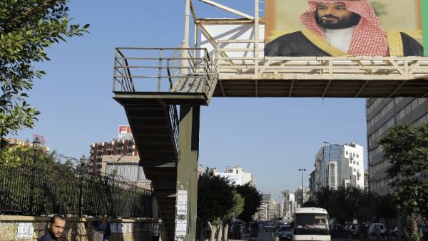 A poster of Saudi Crown Prince Mohammed bin Salman hangs on a pedestrian crossing bridge in the northern Lebanese port city of Tripoli (Joseph Eid/AFP)