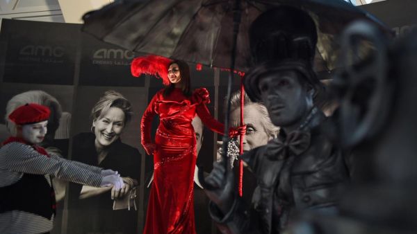 A woman poses for photographs at an invitation-only screening of Black Panther.
(Fayez Nureldine / AFP Photo)