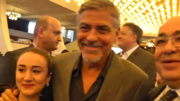Clooney poses for selfies with fans in Armenia. (YouTube)