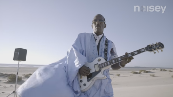 A screenshot from the music video for 'Doueh Shreds in the Moroccan Desert: Guitar Moves.' (YouTube)