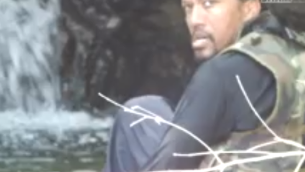 A shaky still from the video that shows German Abu Talha praying and playing in the Syrian Latakia province. (YouTube)