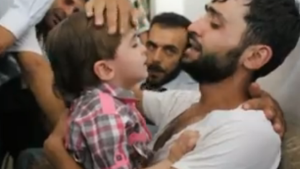 Screenshot of a young Syrian boy being reunited with his father, who believed he was dead. (YouTube)