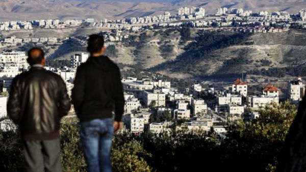 Palestinians look on after major settlement expansion was announced in the days following US President Donald Trump's January 20 inauguration (AFP/THOMAS COEX)