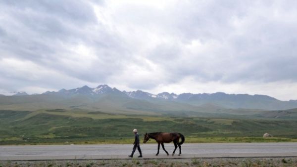 A man walks along a road at a pasture in Kazakhstan situated along the ancient Silk Road. (AFP/File)