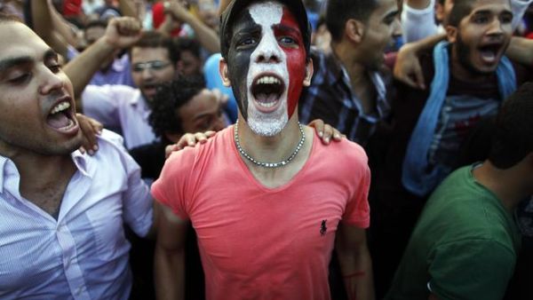 Egyptians shout slogans against President Mohamed Morsi and the Muslim Brotherhood as hundreds of thousands of Egyptian demonstrators gather at the presidential palace during a protest calling for the ouster of Morsi on July 1, 2013 in Cairo.