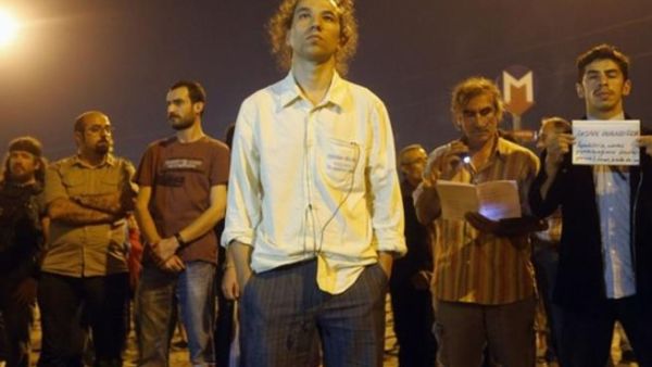 Erdem Gundus, pictured here, sparked a protest by standing silently for hours in Taksim Square in Istanbul overnight. He is currently trending on Twitter under the hashtag #StandingMan.