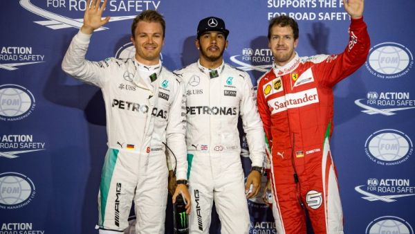 Mercedes AMG Petronas F1 Team's British driver Lewis Hamilton (C) stands next to Mercedes AMG Petronas F1 Team's German driver Nico Rosberg (L) and Ferrari's German driver Sebastian Vettel after securing the pole position in the Bahrain Formula One Grand Prix following the qualifying session at the Sakhir circuit in Manama on April 2, 2016, a day ahead of the race. AFP PHOTO / ANDREJ ISAKOVIC
ANDREJ ISAKOVIC / AFP