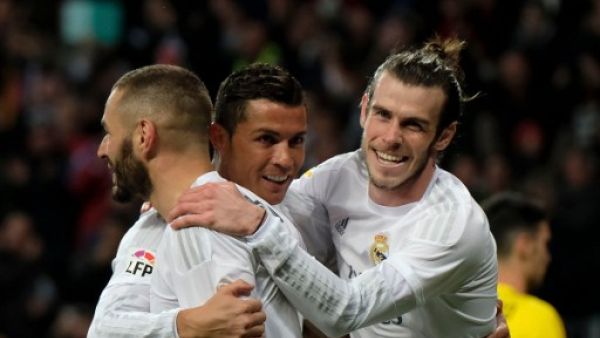 Real Madrid's Welsh forward Gareth Bale (R), Real Madrid's French forward Karim Benzema (L) and Real Madrid's Portuguese forward Cristiano Ronaldo (C) celebrate scoring during the Spanish league football match Real Madrid CF vs Sevilla FC at the Santiago Bernabeu stadium in Madrid on March 20, 2016.
PEDRO ARMESTRE / AFP